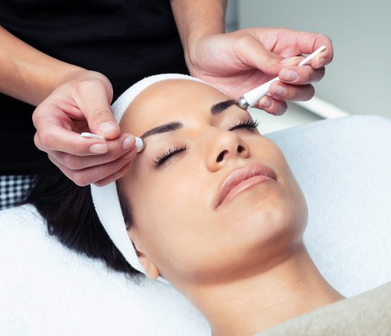 Cosmetologist making the eyes contour therapy for rejuvenation t Shot of cosmetologist making the eyes contour therapy for rejuvenation to woman on the spa center.